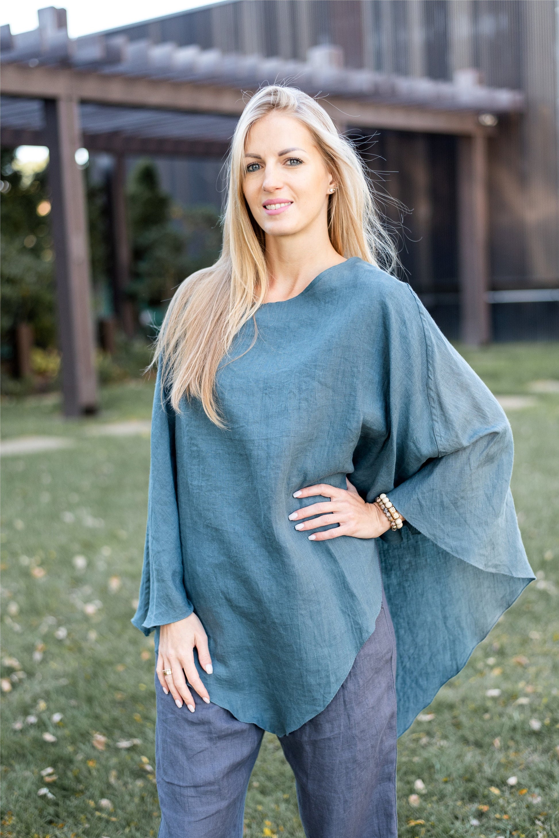Close-up of the poncho's linen texture, emphasizing the natural wrinkles.