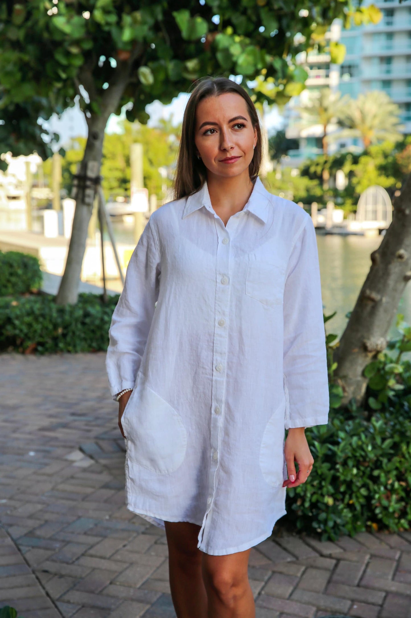 Full-length display of the linen button-up dress, capturing its relaxed silhouette.