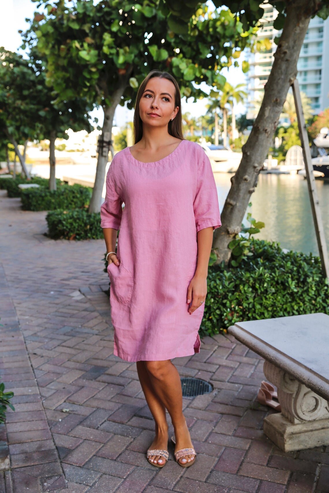 Woman showcasing the comfortable fit of a pre-washed and pre-shrunk linen tunic.