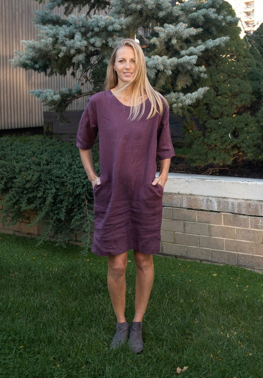 Woman adorned in a fall boho linen tunic dress with 3/4 sleeves.