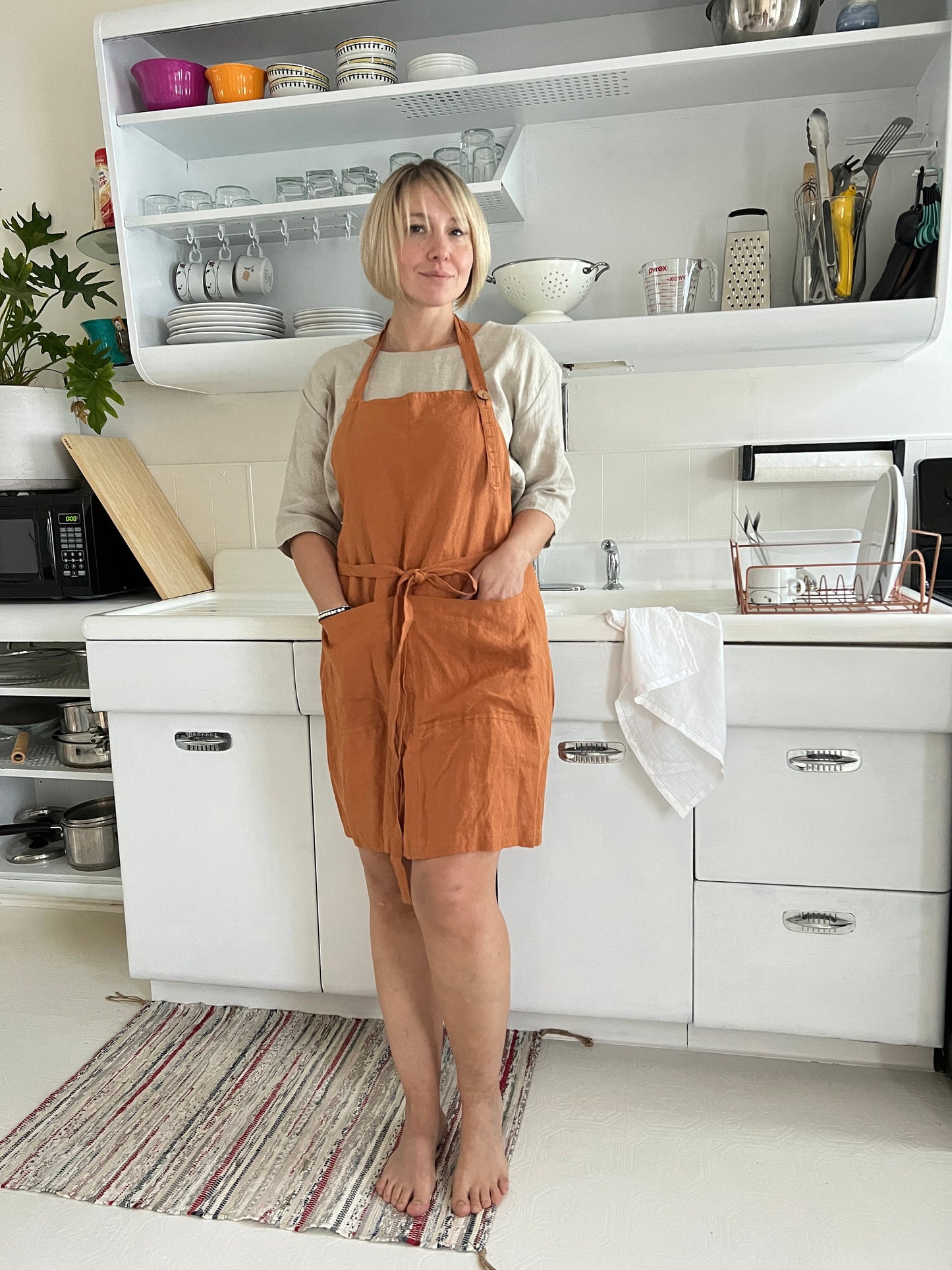 Woman wearing the timeless Linen Apron, exuding style and grace.
