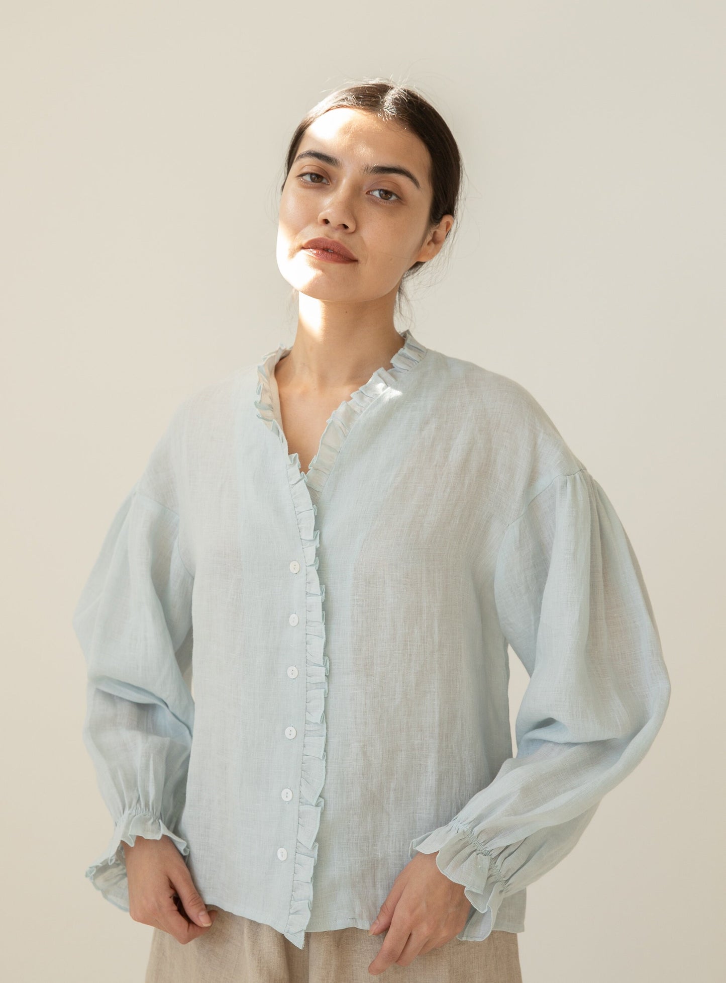 Breathable Linen Blouse with delicate ruffle placket detail.