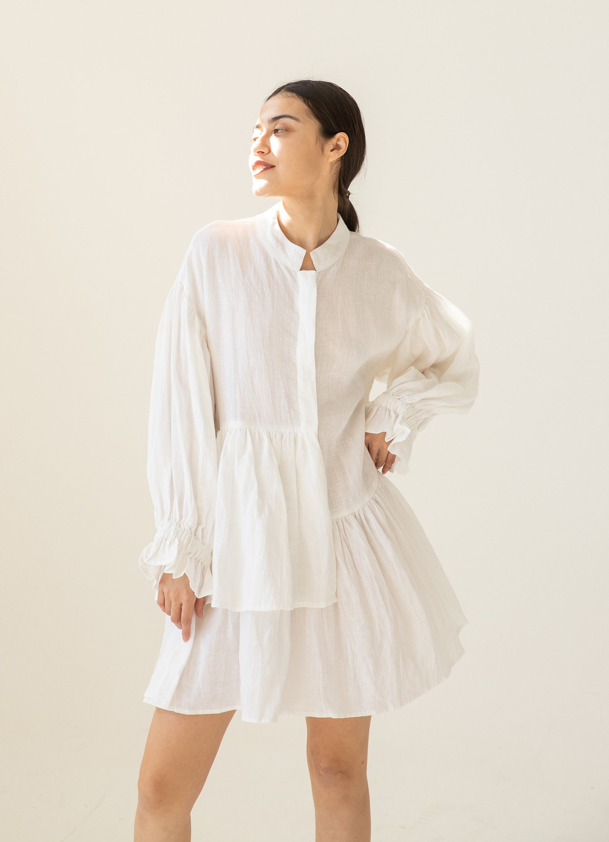 Model showcasing the elegant drape of the Asymmetric Linen Tunic.