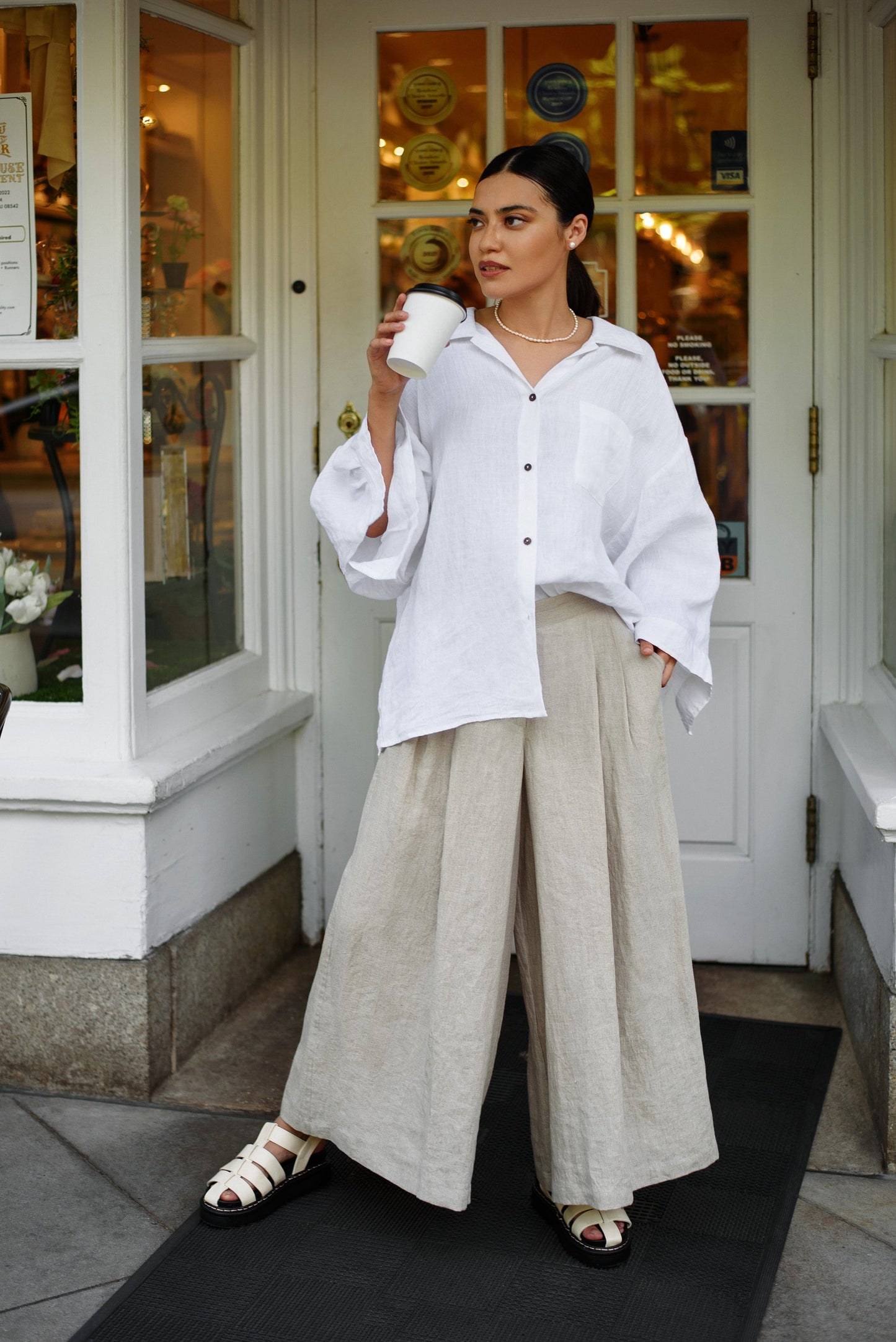 Oversized linen shirt in white, relaxed fit visible from the front.