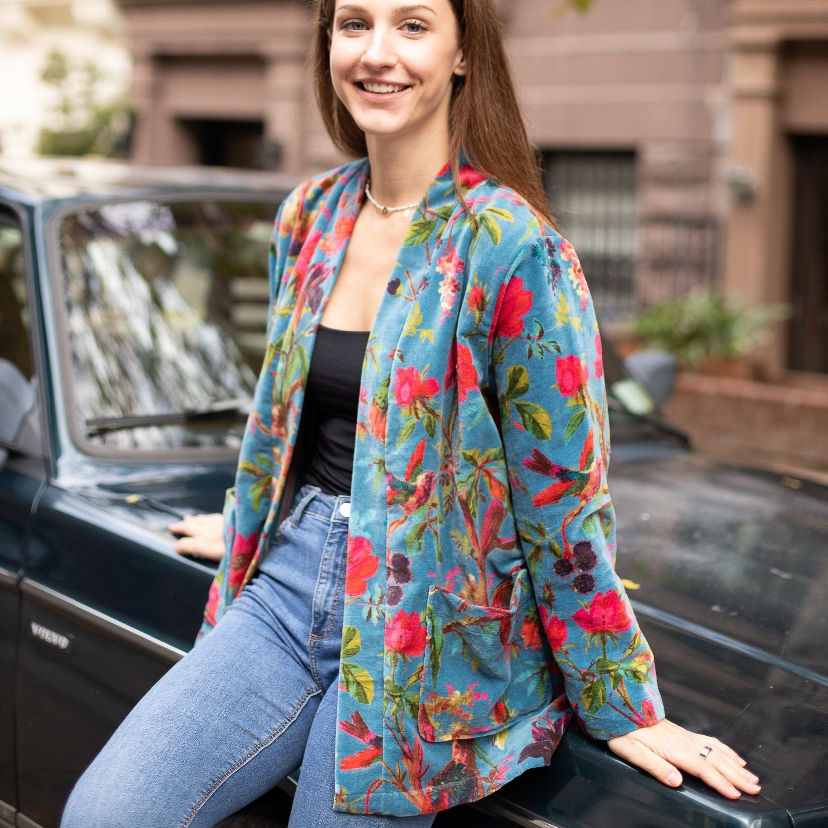 Model leaning on the car while adorned in the Japanese-Inspired Velvet Kimono Cardigan with Bird Print Short Jacket