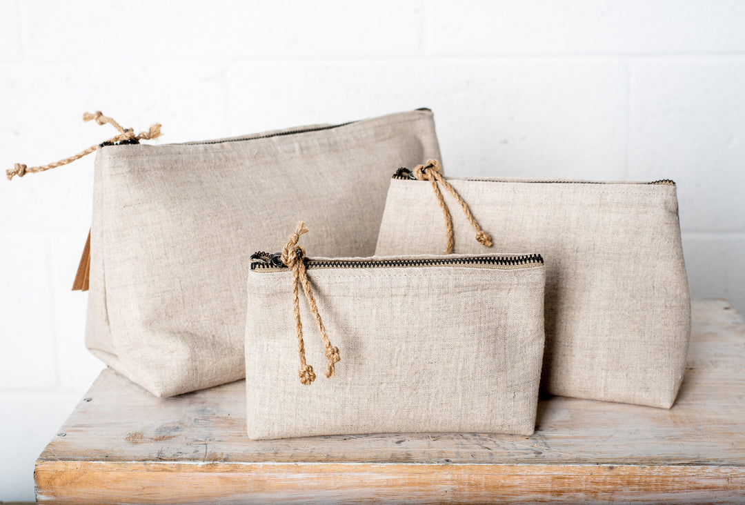 Detailed view of the texture and wrinkles on medium-weight linen cosmetic pouches.