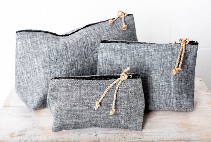 Trio of linen cosmetic bags in varying sizes, showcasing European craftsmanship.