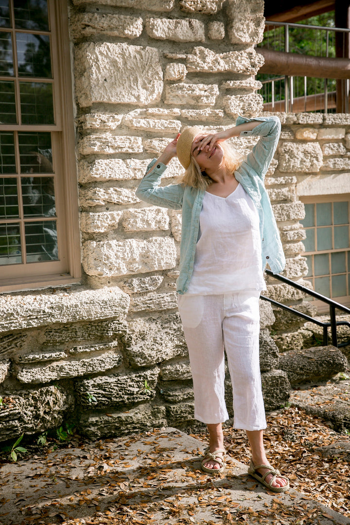 Woman exuding casual elegance in linen crop pants.