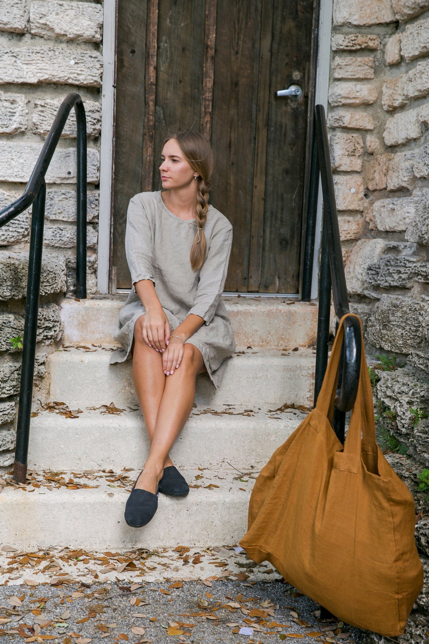 Bohemian elegance: Woman in a soft and oversized linen summer outfit.