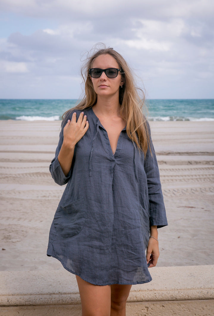 Graceful silhouette of a woman enjoying summer in a linen beach tunic.