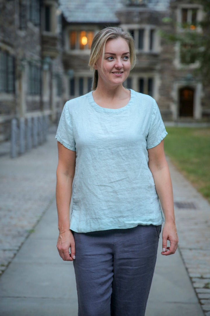 Young charming woman is wearing essential linen top short sleeve