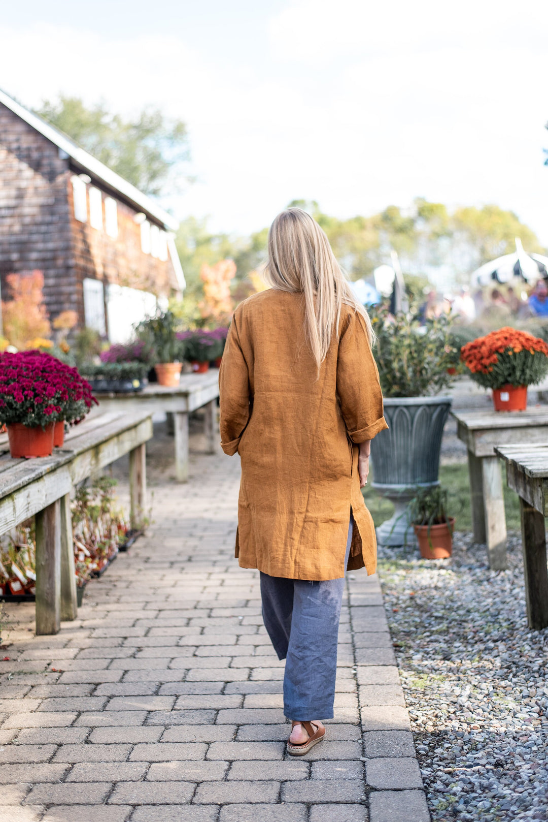 Profile shot of the Linen Open Coat, highlighting its length and flow.