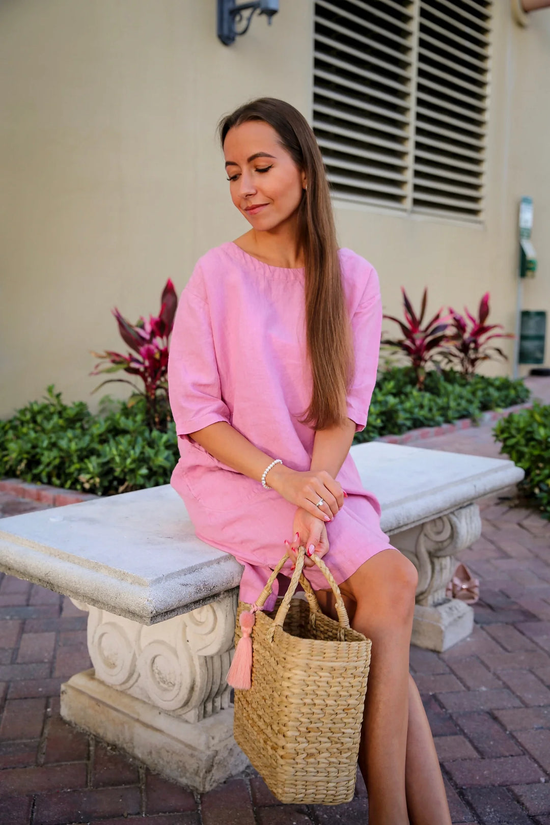 Woman enjoying a breeze in a fall linen dress, reflecting sustainable fashion choices.