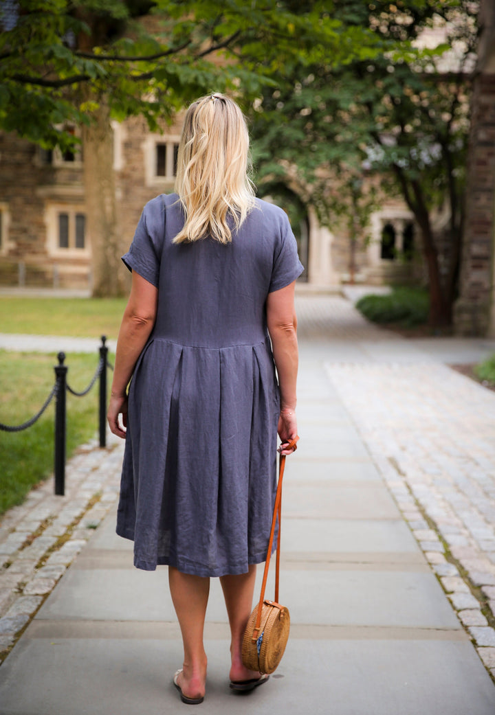 Airy and elegant: Woman basking in the sun wearing the Linen Adri Dress.