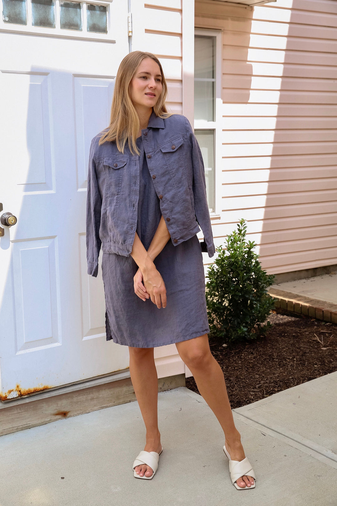 Woman exuding sophistication in a pre-washed and pre-shrunk linen dress.