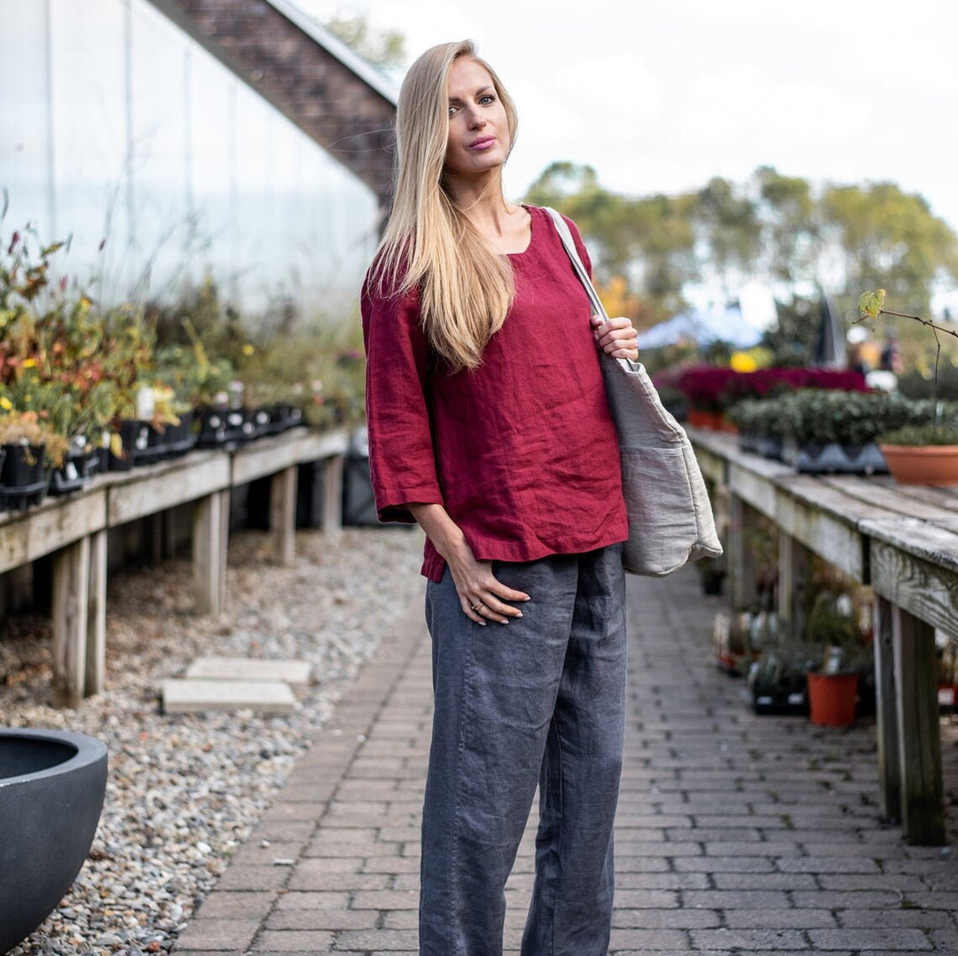 Side profile of a woman wearing linen wide-leg pants, emphasizing fit.