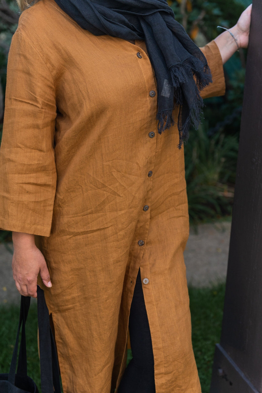 Elegant silhouette of a woman adorned in a mustard linen duster with caftan vibes.