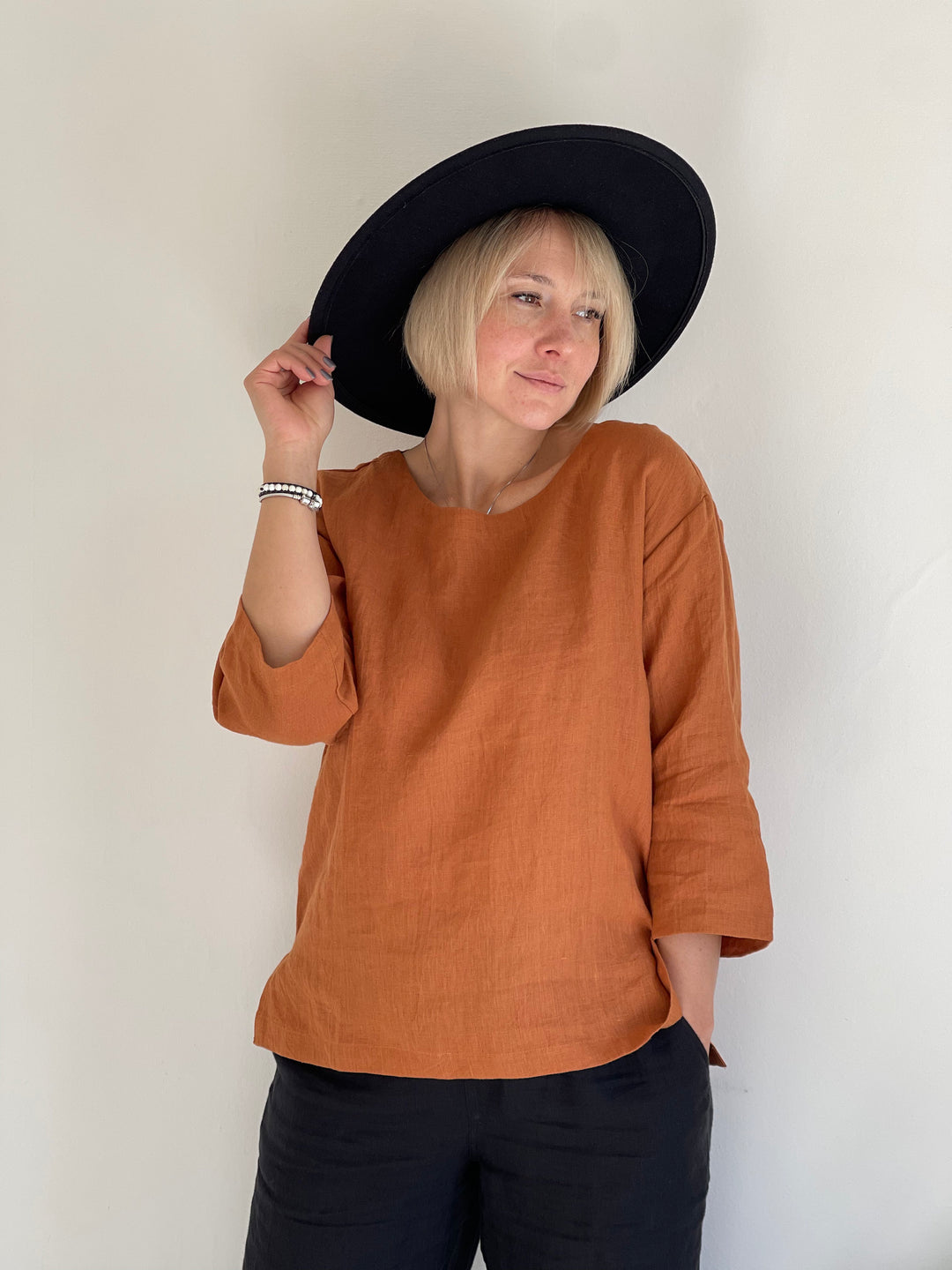 Elegant Linen Bella Top in vibrant rust shade.