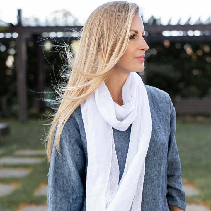 Woman draped in the linen sheer scarf, emphasizing its generous length.