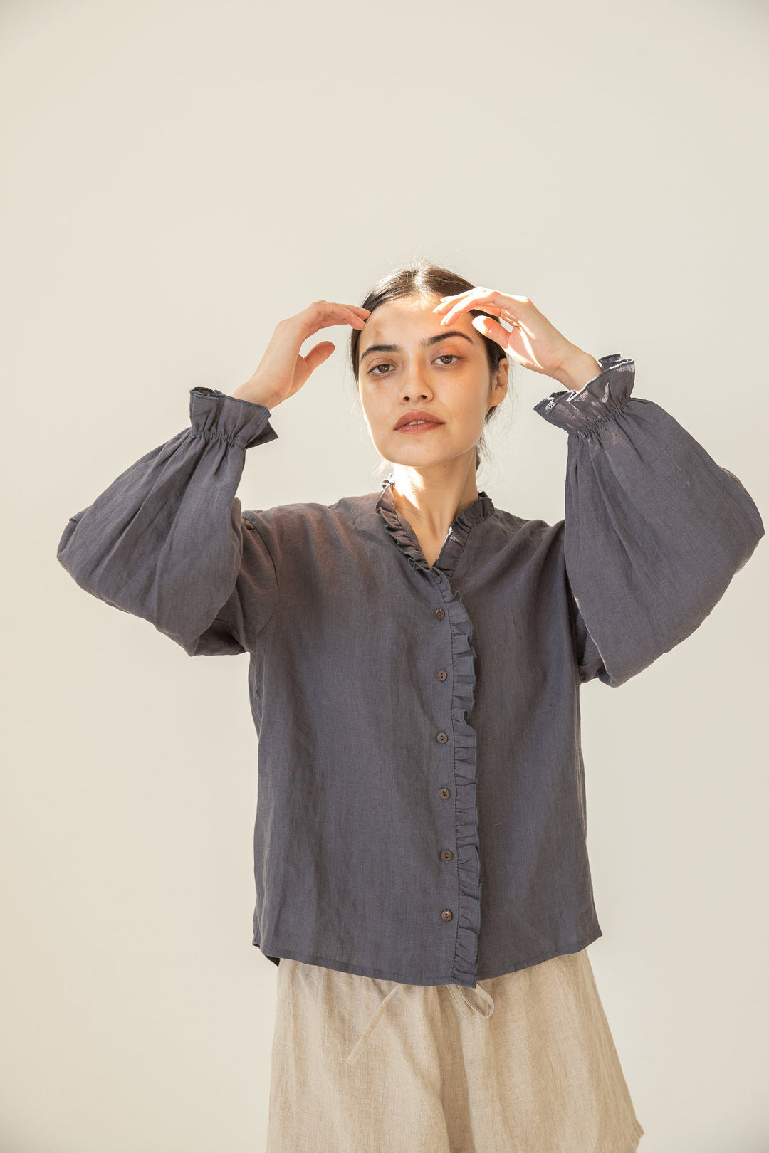 Close-up of the Linen Blouse's button-front and ruffle accents.