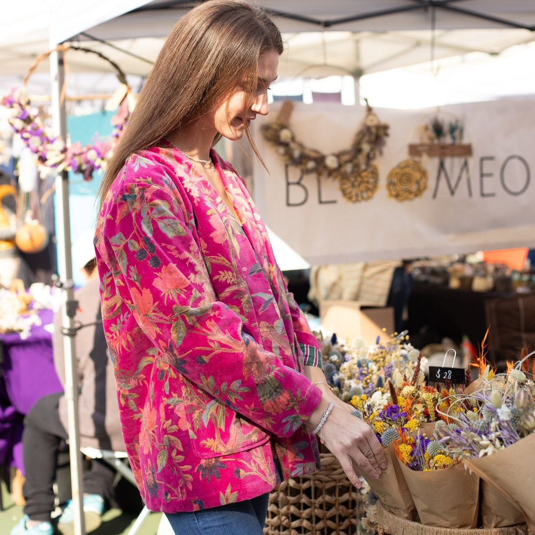 Model admiring flowers in the Japanese-Inspired Velvet Kimono Cardigan with Pink Bird Print Short Jacket.